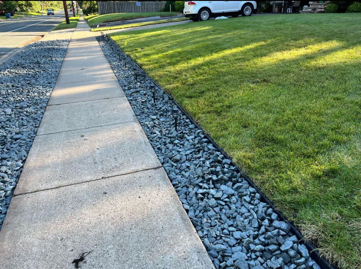 Trap Rock Edging and Diamond Border Along a Front Walkway
